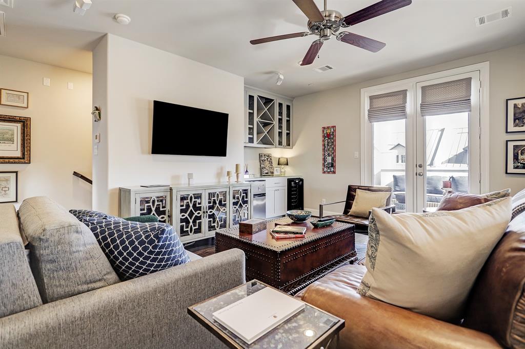 A tidy living room with two couches, a TV, and a living room table with a few items on top of it.