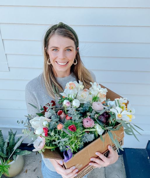 Alex Lekometros of Bungalow Blooms holding a box of flowers