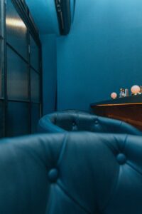 Blue leather sofa beside brown wooden table