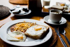 Breakfast spread including eggs, coffee, and homefries.