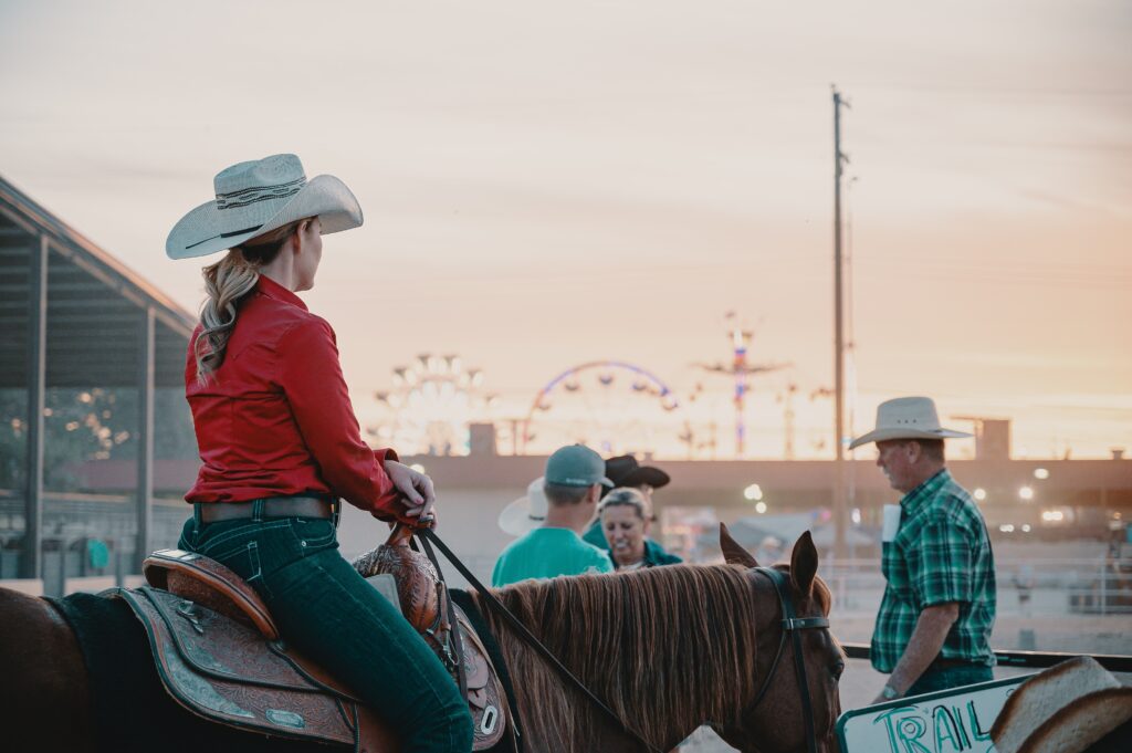 Woman sitting on a horse at a fair